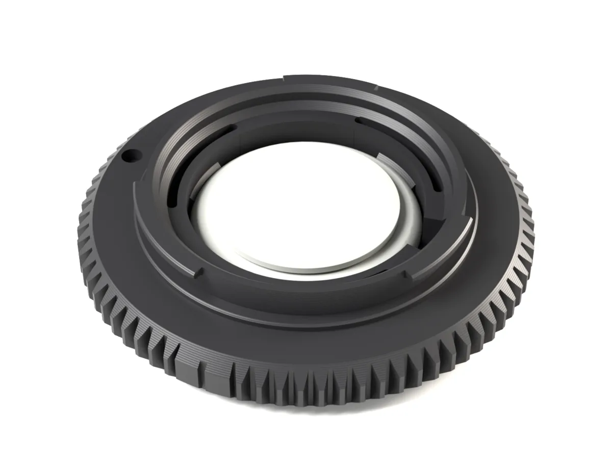 Sony E body cap with an AirTag snapped into its pocket, seen from the camera side