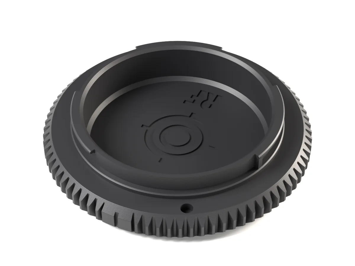 Canon RF body cap, 3D printed, seen from the camera side with its bayonet lugs and locking pin hole