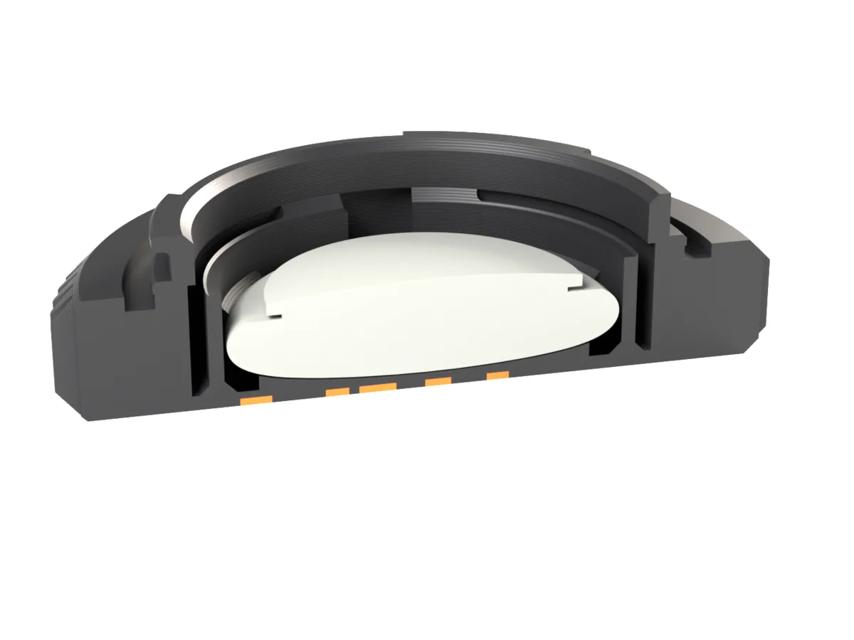 Cut through the Fujifilm X AirTag body cap: the AirTag held by the snap ring behind the face