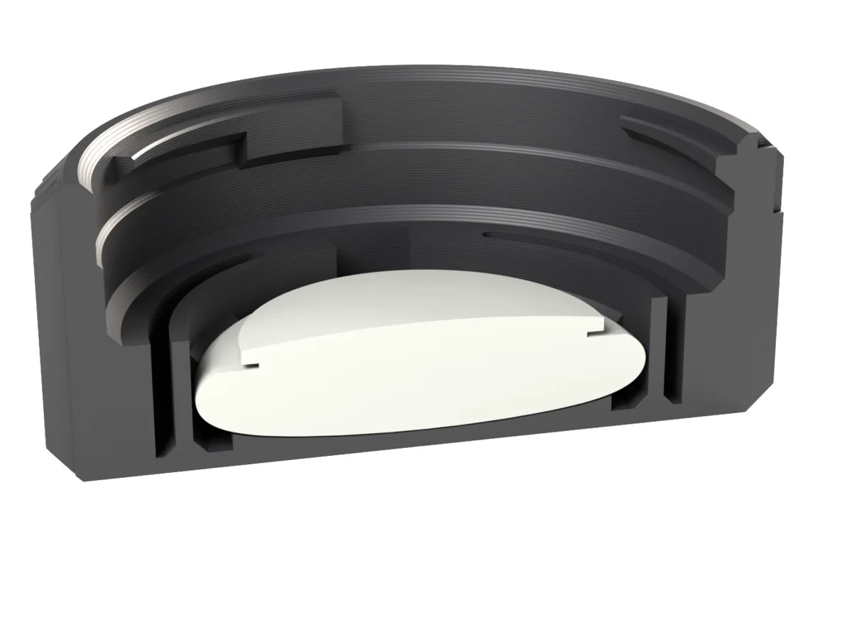 Cut through the Fujifilm X AirTag rear cap: the AirTag held by the snap ring below the lens room