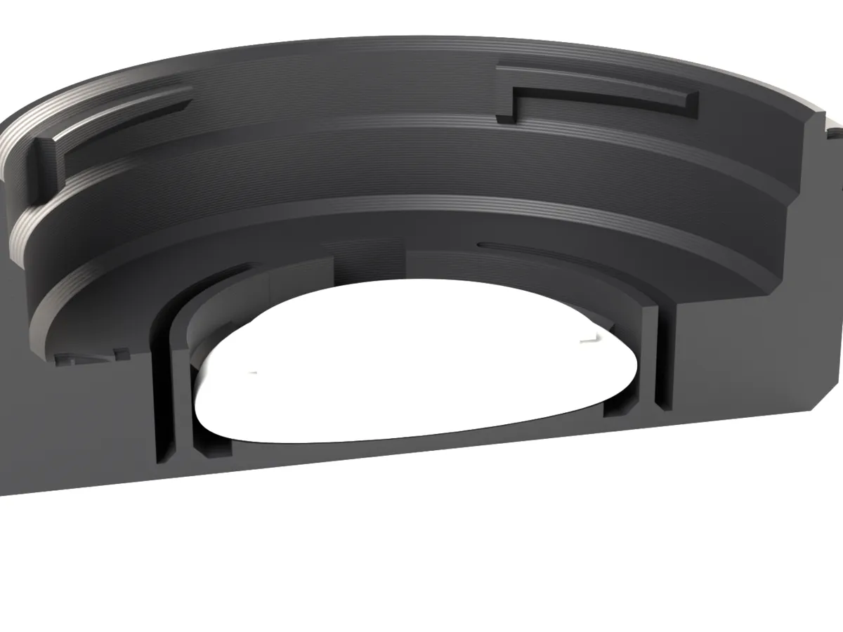Cut through the Nikon Z AirTag rear cap: the AirTag held by the snap ring below the lens room