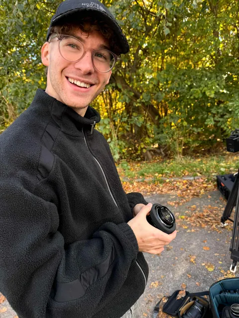 Basti, director of photography, holding a lens with a printed focus ring
